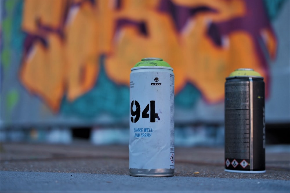 white and green can on gray concrete floor