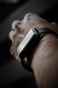 person wearing black and silver watch