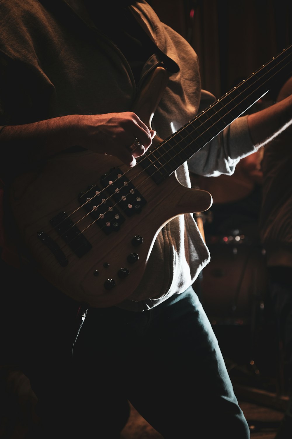 man in white shirt playing electric guitar