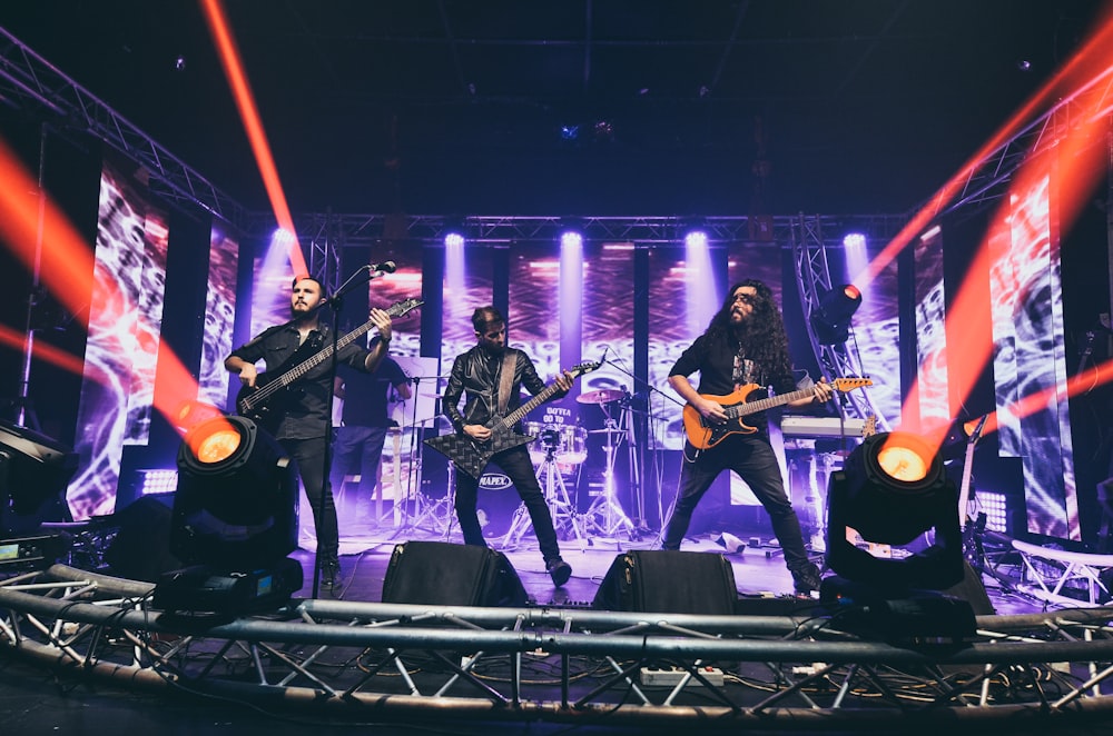 a group of men standing on top of a stage