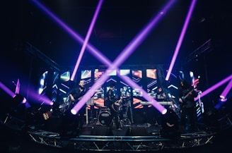 people standing on stage with blue lights