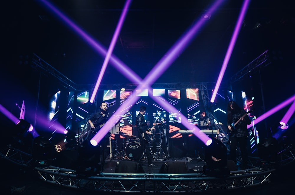 people standing on stage with blue lights