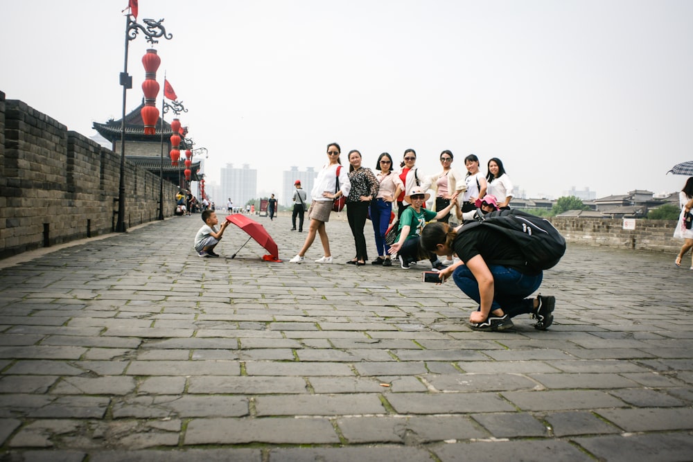 people sitting on concrete pavement during daytime