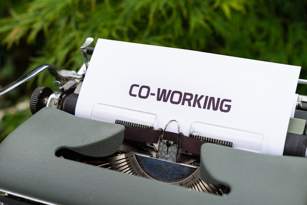 white and black typewriter on green grass during daytime