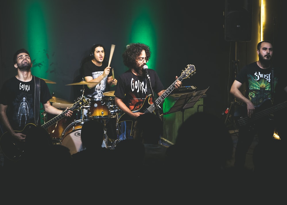 man in black and white crew neck t-shirt playing electric guitar