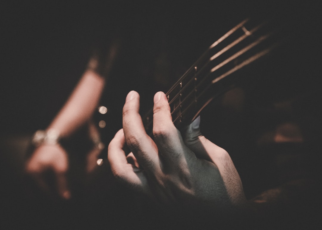 person holding fork in grayscale photography