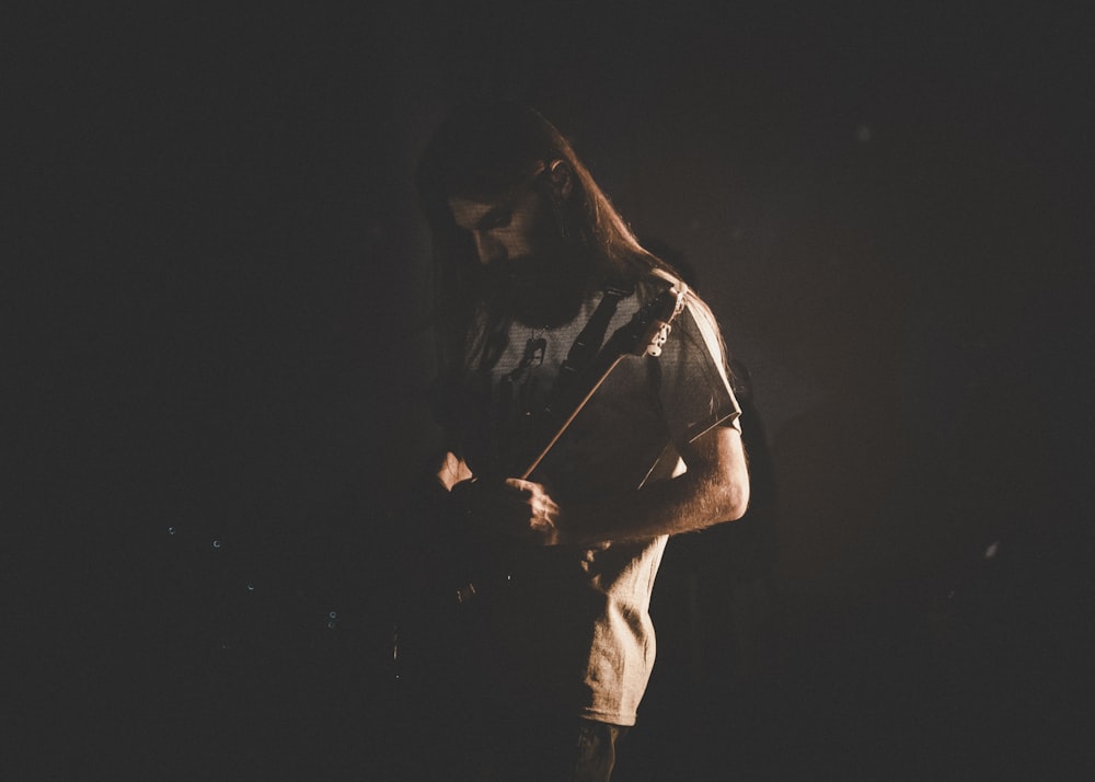 man in white t-shirt and black cap