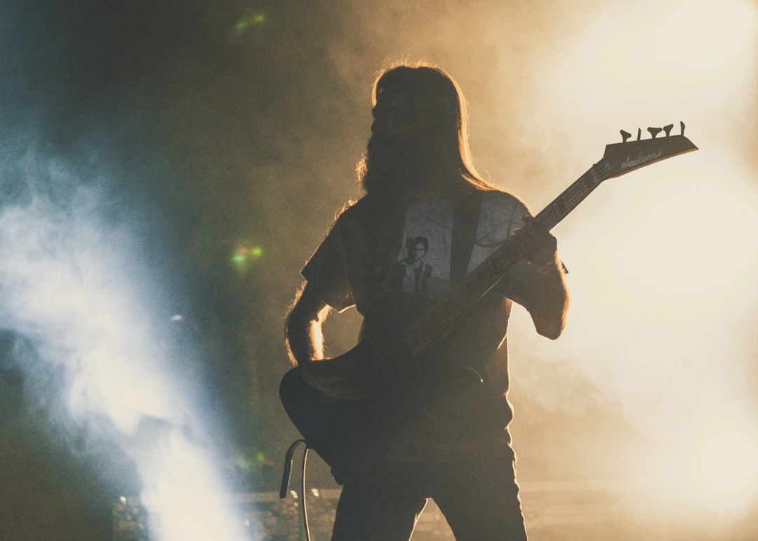 man playing electric guitar on stage