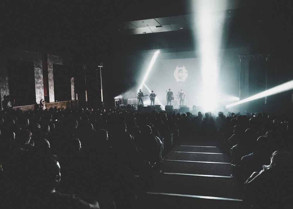 people sitting on chairs watching concert