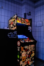 Technician repairing an arcade machine on site.