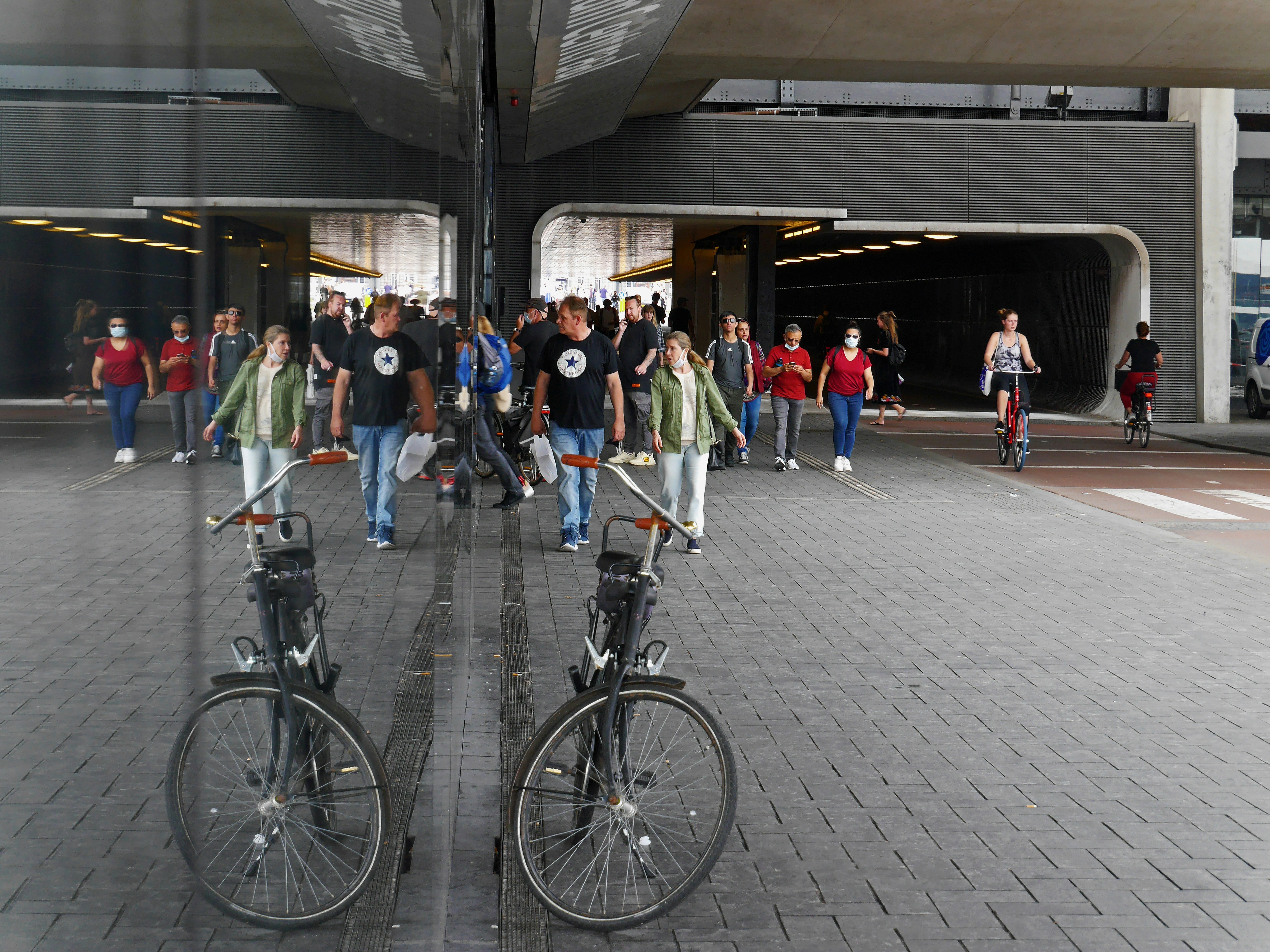 people riding bicycle on road during daytime, Street photo of people, walking through the subway corridor, close to Central Station in Amsterdam city. This tunnel connects the city center side with the North side of the city and with the ferries, going North.</p><p>Free street hotography of Amsterdam city by Fons Heijnsbroek, 2020, The Netherlands.