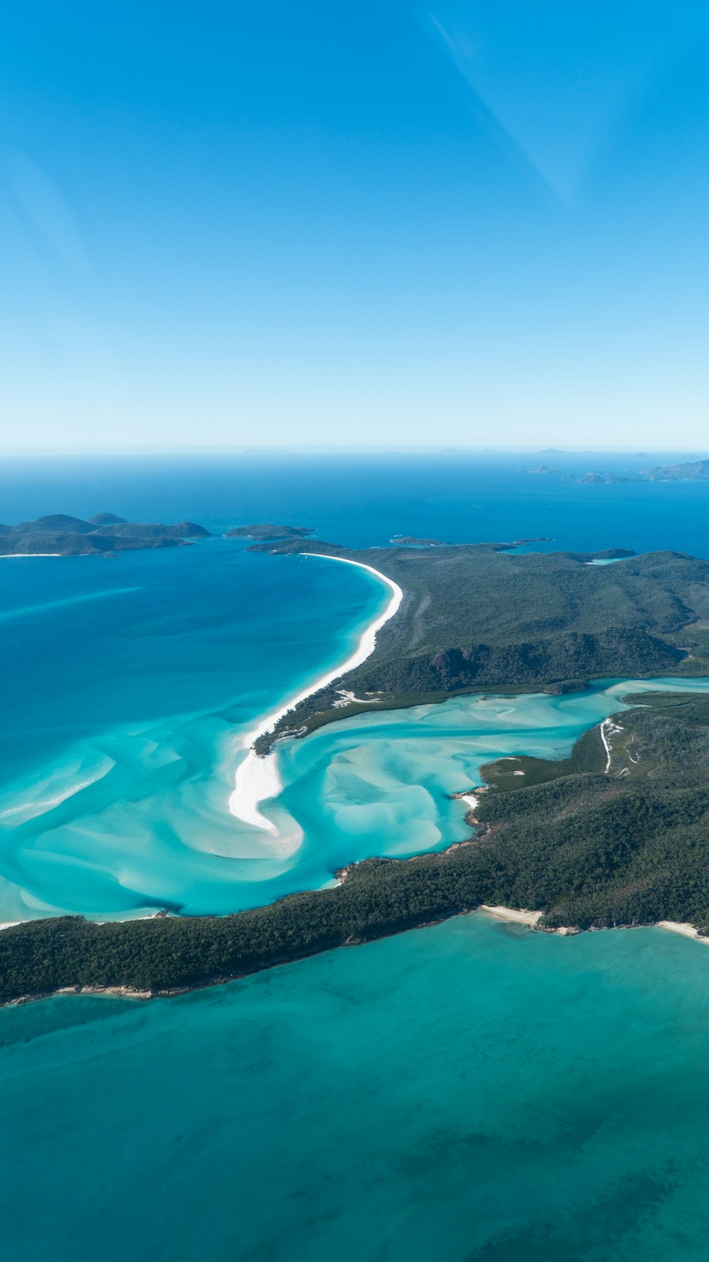 aerial view of green trees and blue sea during daytime