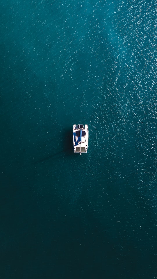 white boat on body of water during daytime in Whitehaven Beach Australia