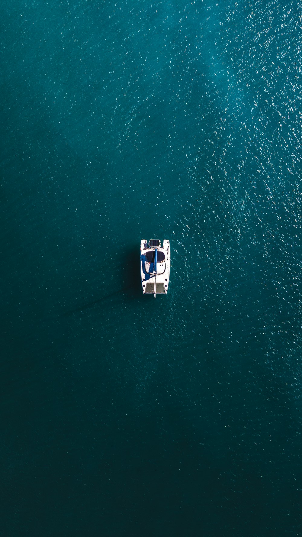 white boat on body of water during daytime