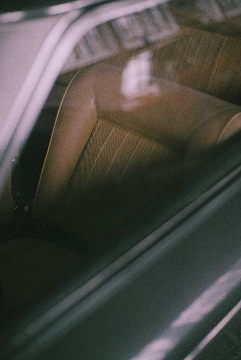 person in black leather car seat