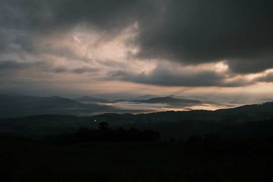 silhouette of mountains under cloudy sky during sunset in Virachey National Park Cambodia