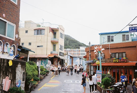 people walking on street during daytime in Gamcheon Culture Village South Korea