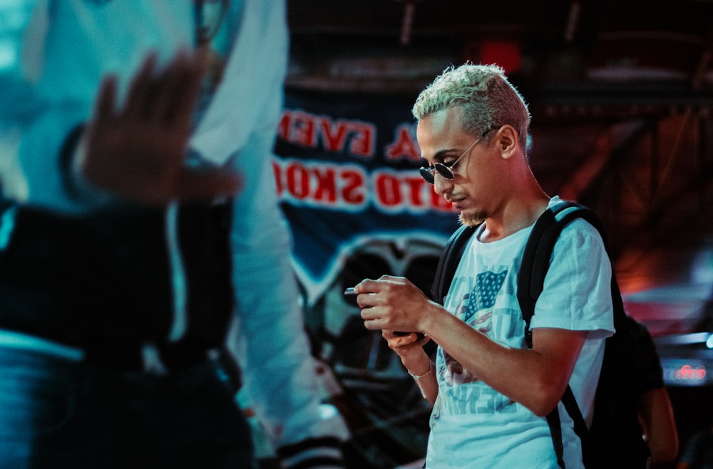 man in blue and white crew neck t-shirt wearing eyeglasses