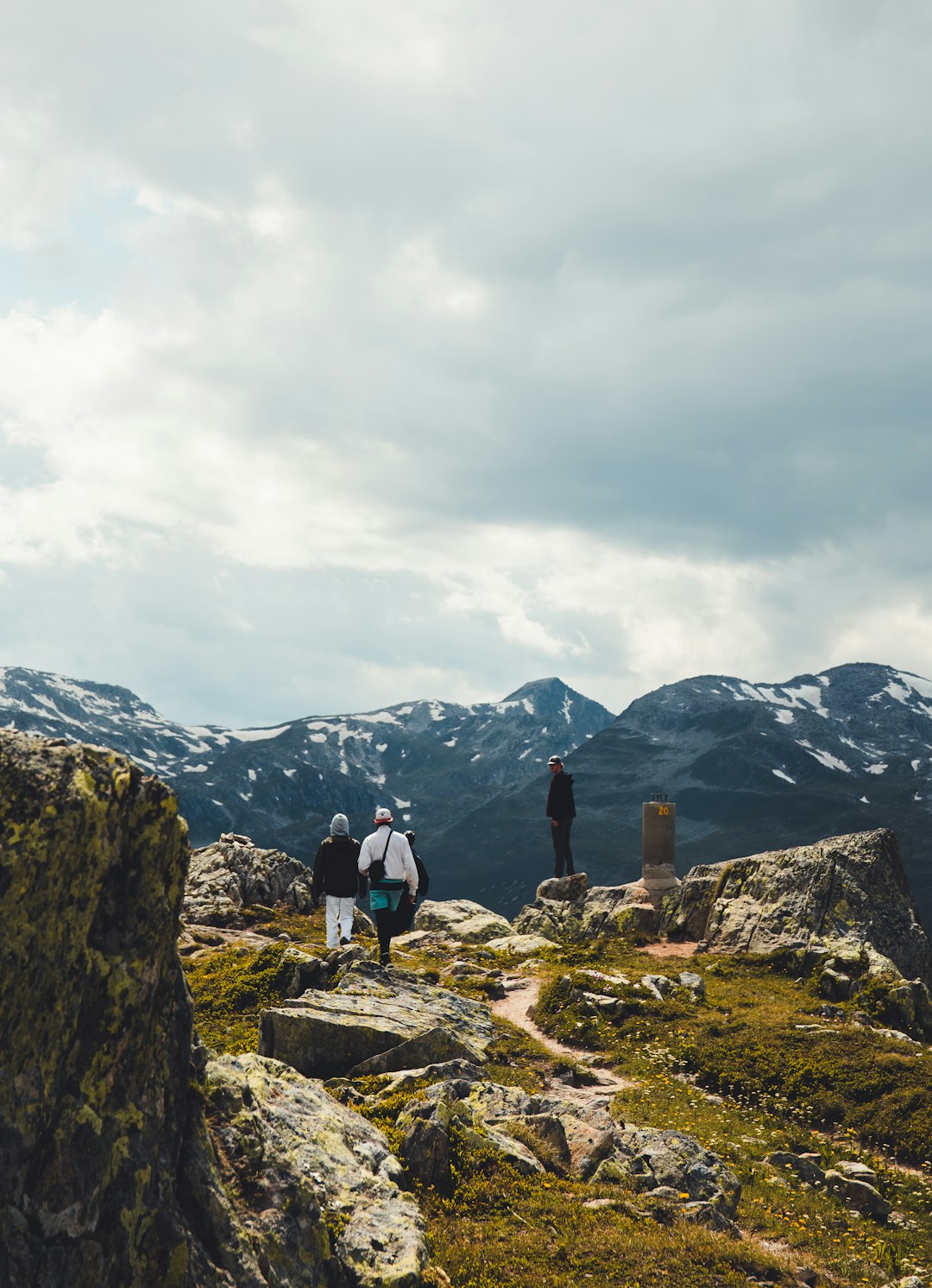 people standing on rocky mountain during daytime