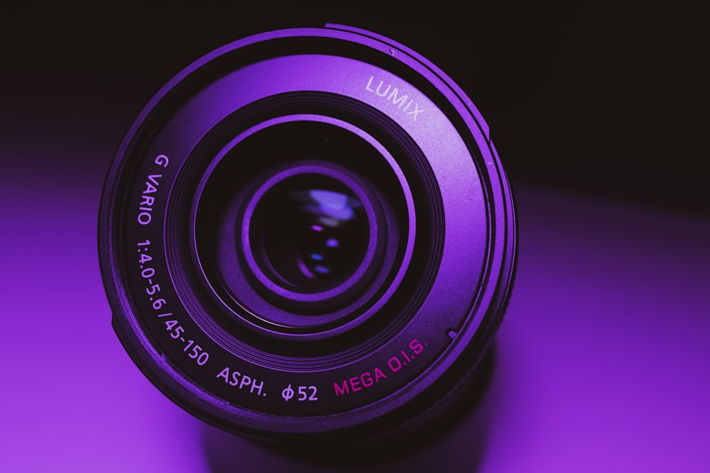 black camera lens on pink surface