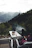Guests enjoying a barbecue at the quincho with the mountains in the background during sunset.