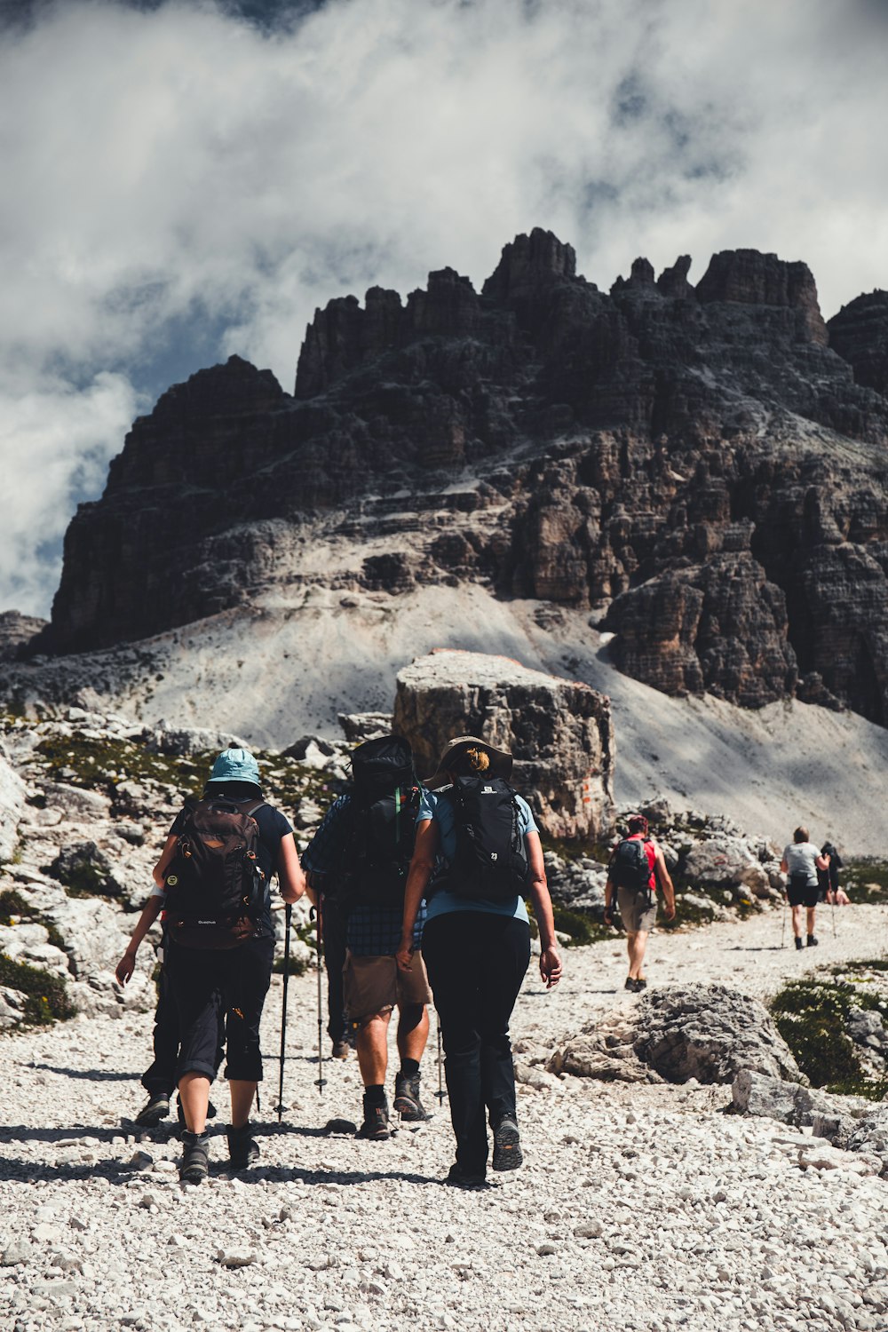 people hiking on rocky mountain during daytime