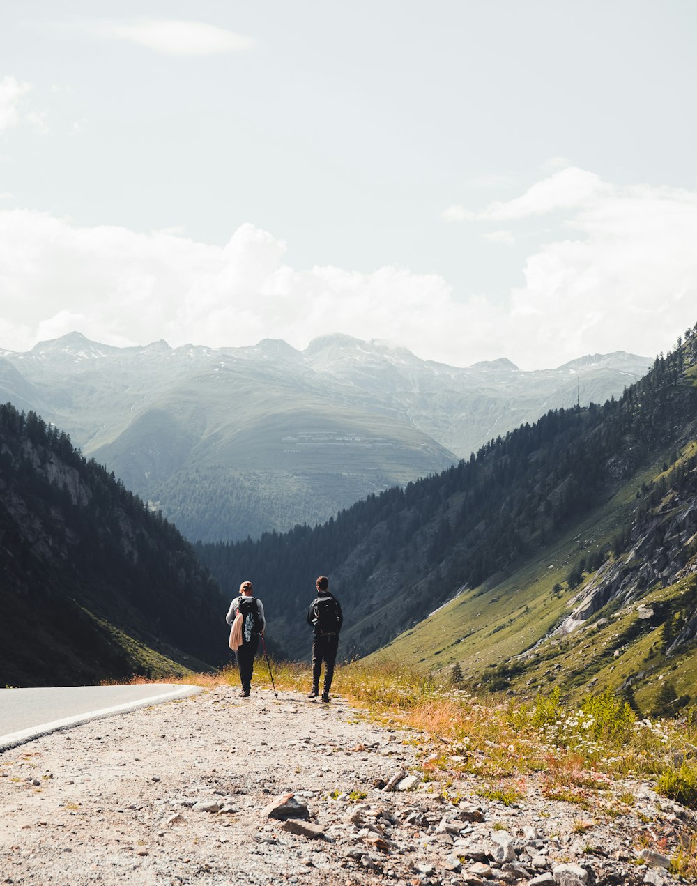 man in black shirt and black shorts walking on road during daytime