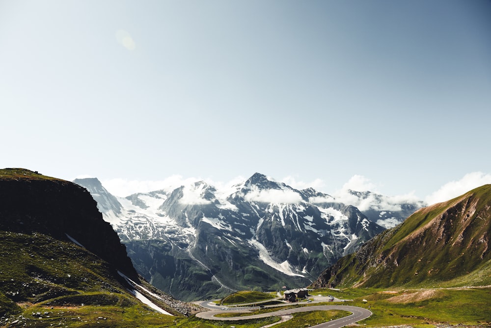 snow covered mountains under cloudy sky during daytime