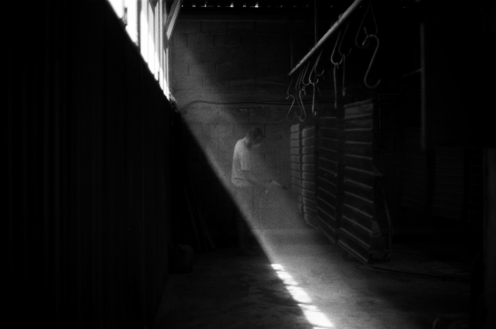 grayscale photo of tunnel with metal railings