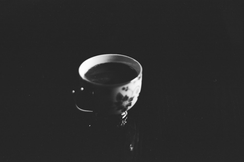 white and black ceramic mug with black liquid