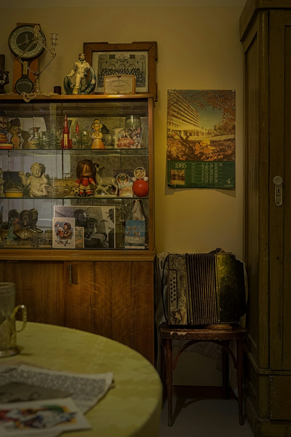 brown wooden cabinet with picture frames