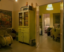 brown wooden cabinet near white wall