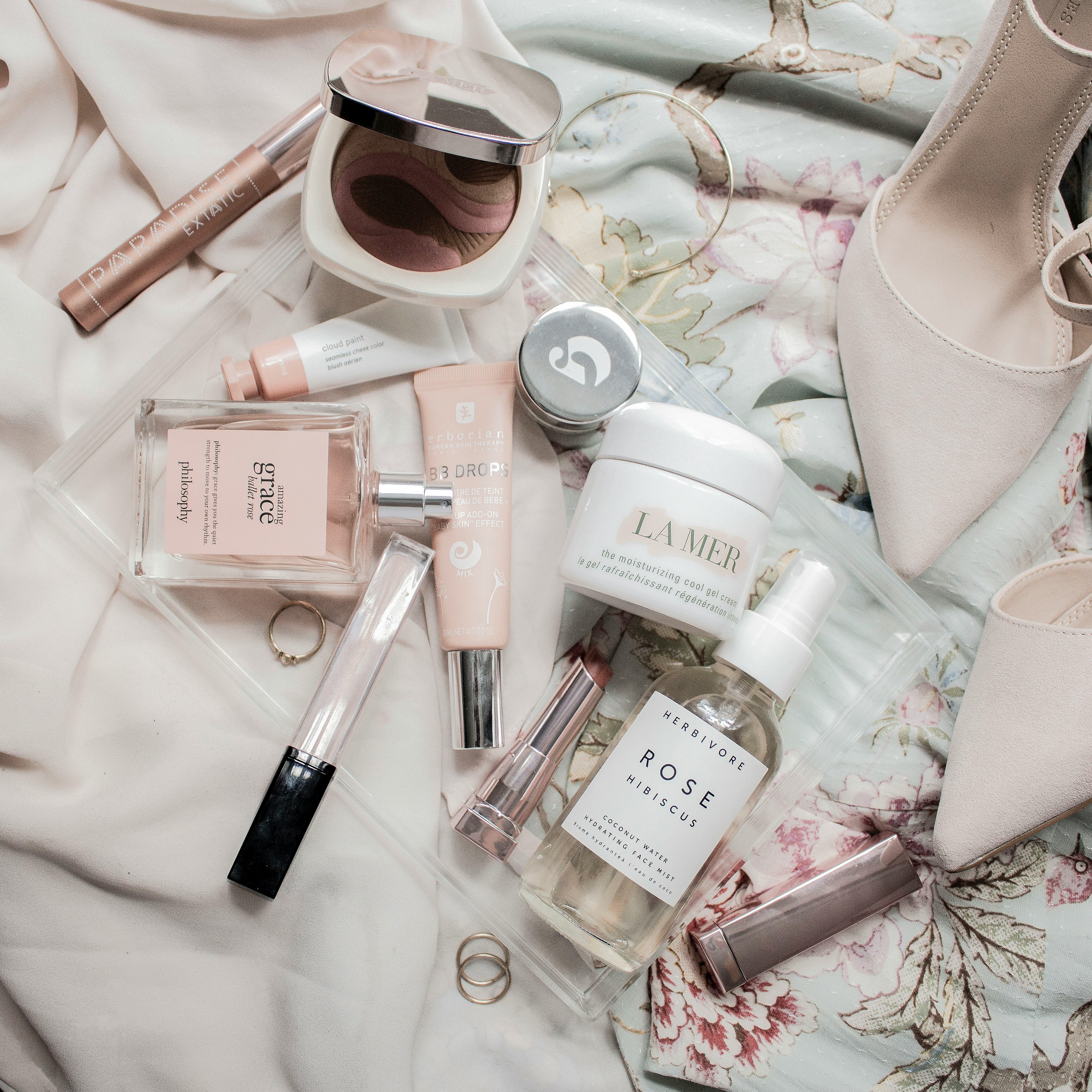 Makeup flatlay of high-end beauty products