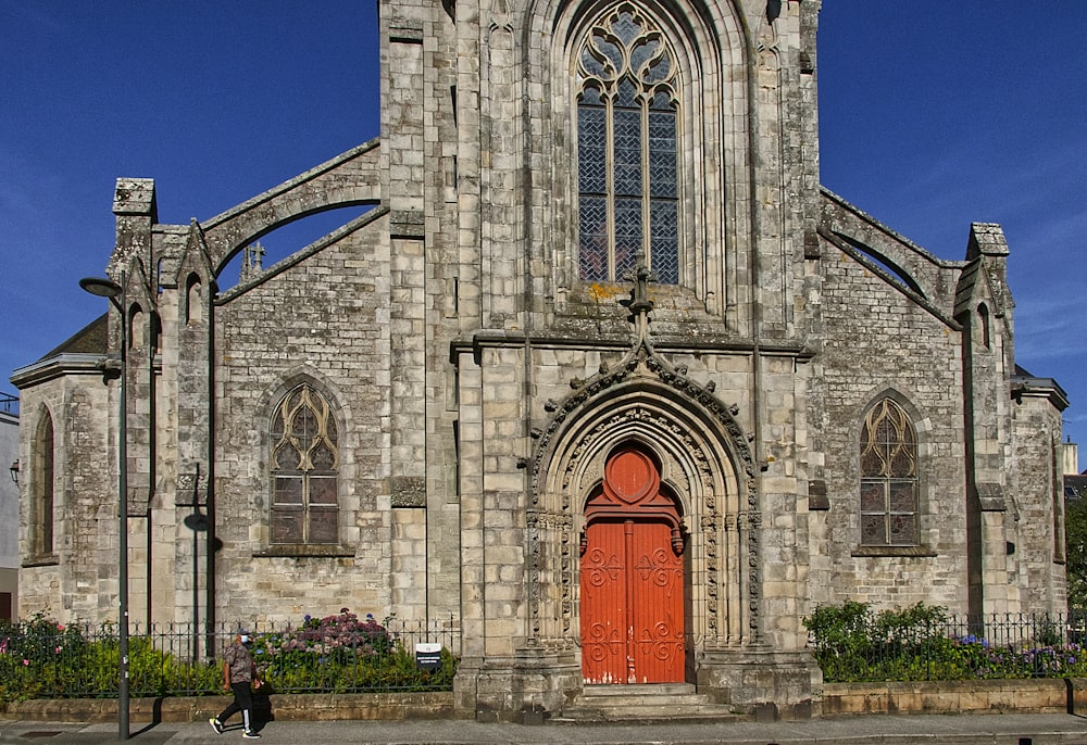 grey concrete church with red door