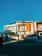 white and brown concrete house under blue sky during daytime