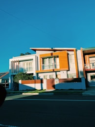 white and brown concrete house under blue sky during daytime