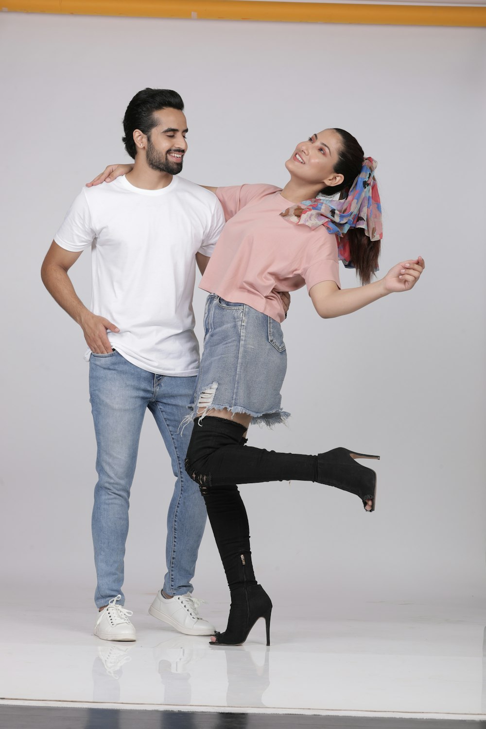 man in white crew neck t-shirt and woman in blue denim jeans