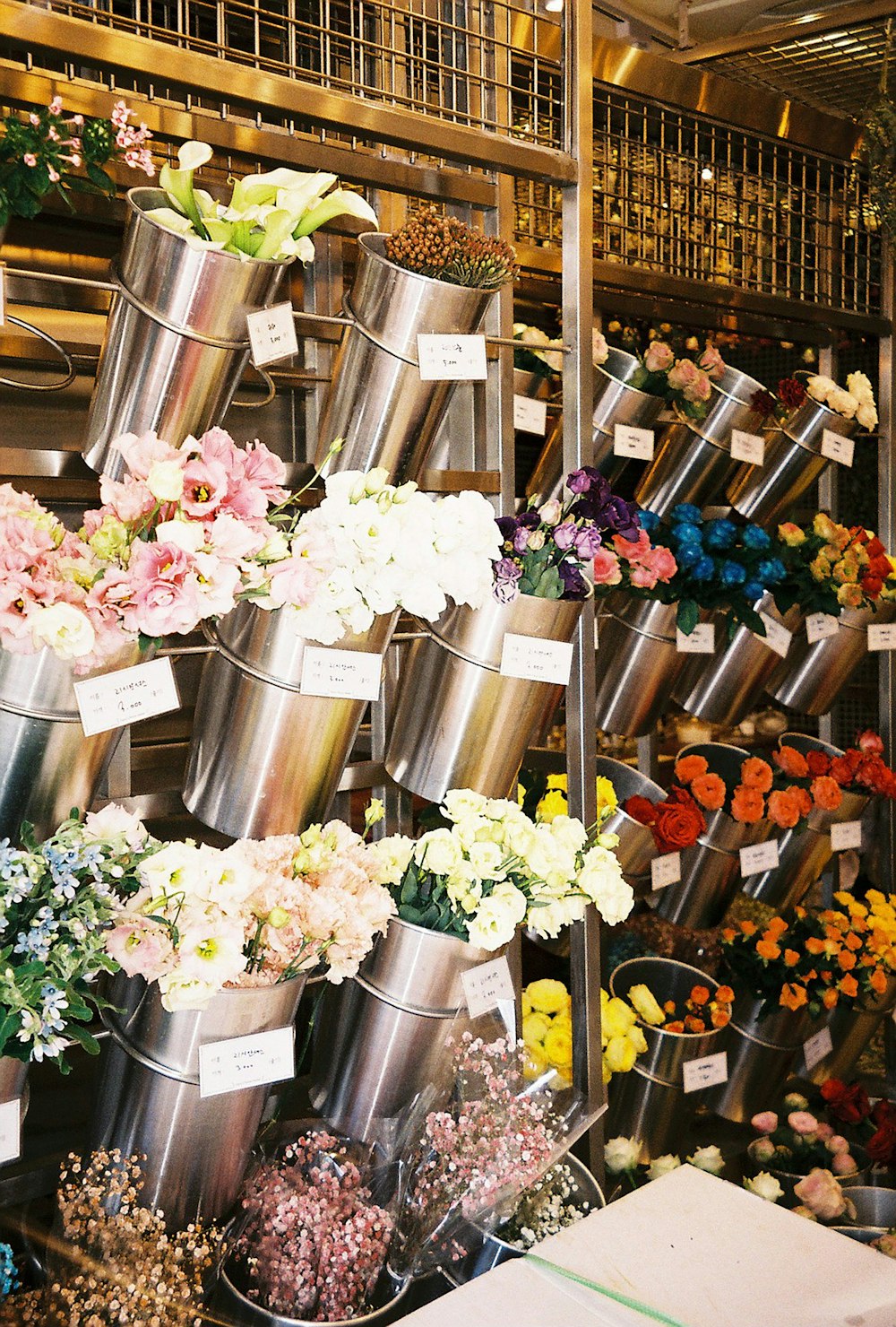 pink and white flowers in stainless steel containers