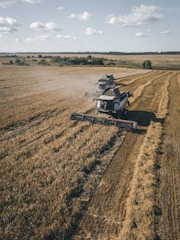brown and black heavy equipment on brown field during daytime