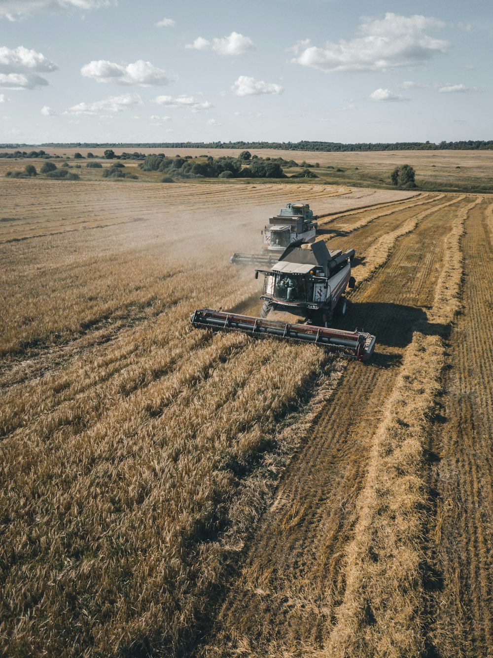 brown and black heavy equipment on brown field during daytime