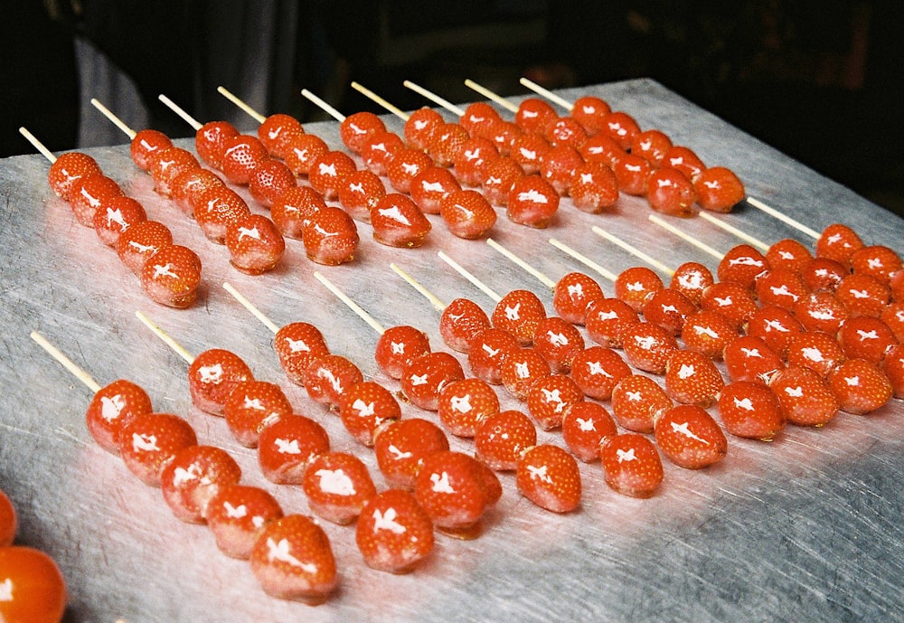 red round candies on white textile