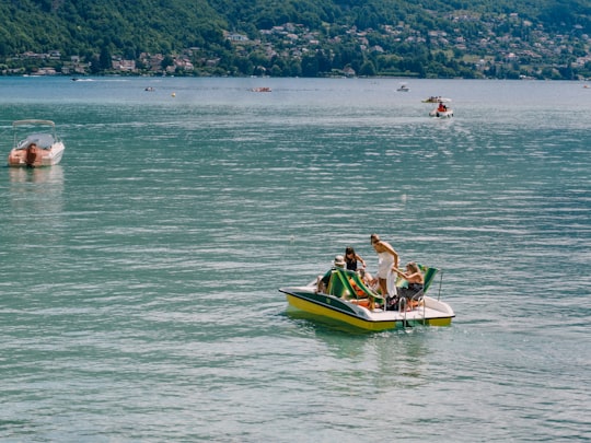 man and woman riding yellow and green kayak on sea during daytime in Lac d'Annecy France