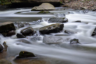 water falls with rocks on the side