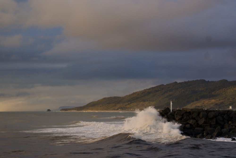 ocean waves crashing on shore during daytime