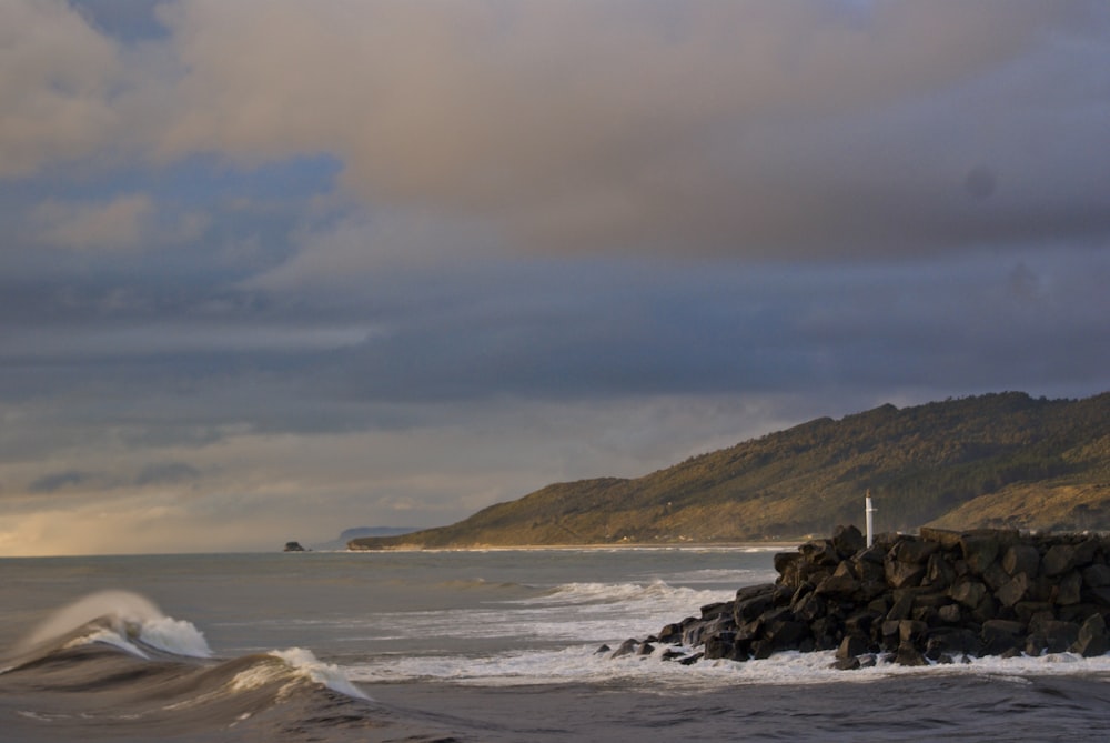 ocean waves crashing on shore during daytime