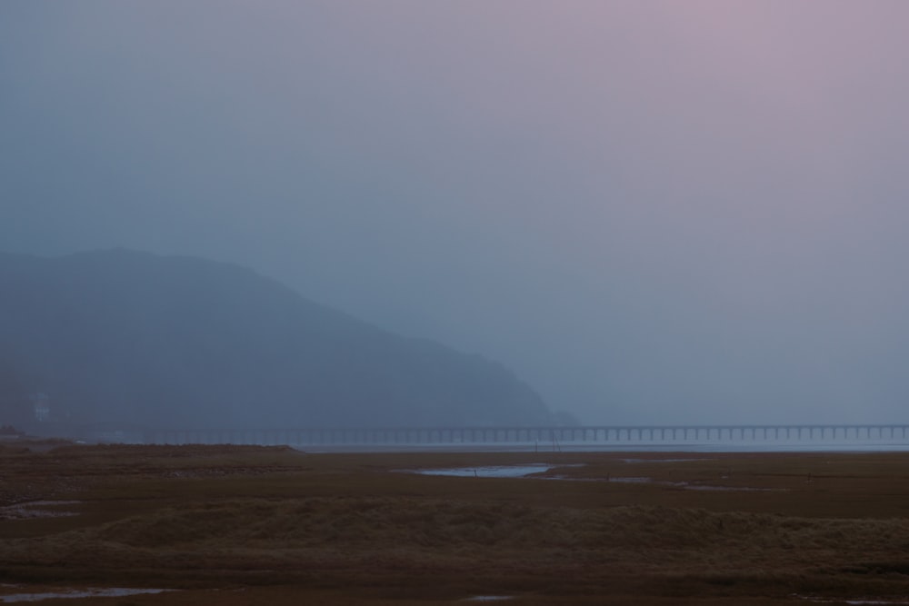 body of water near mountain during daytime