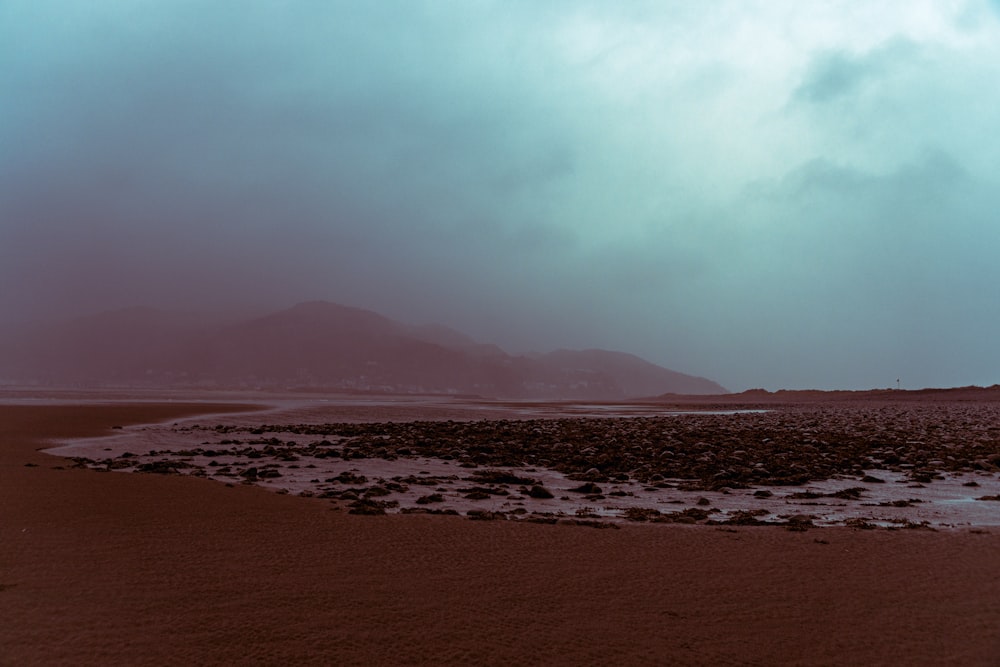 silhouette of mountain under cloudy sky during daytime