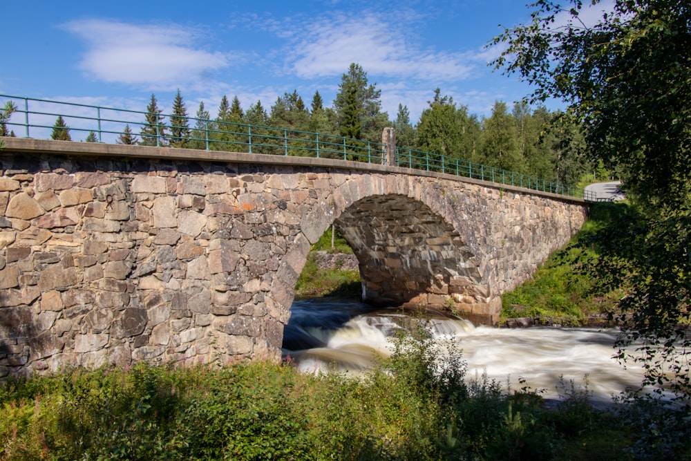 gray concrete bridge over river during daytime