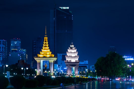 white and gold concrete building during night time in Phnom Penh Cambodia