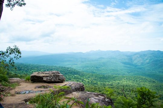 green grass field near mountain during daytime in Kirirom National Park Cambodia